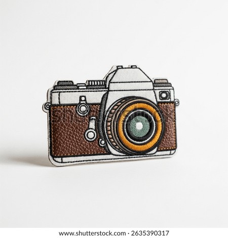 textile patch in the form of a camera on a white background