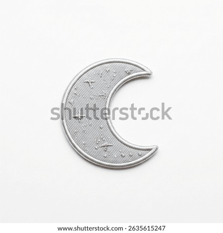 textile patch in the form of a moon on a white background