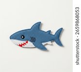 textile patch in the form of a shark on a white background