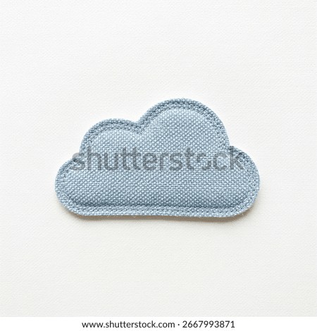 textile patch in the form of sky clouds on a gray background