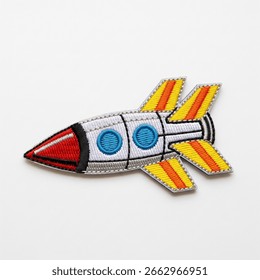 textile patch in the form of a spaceship on a white background