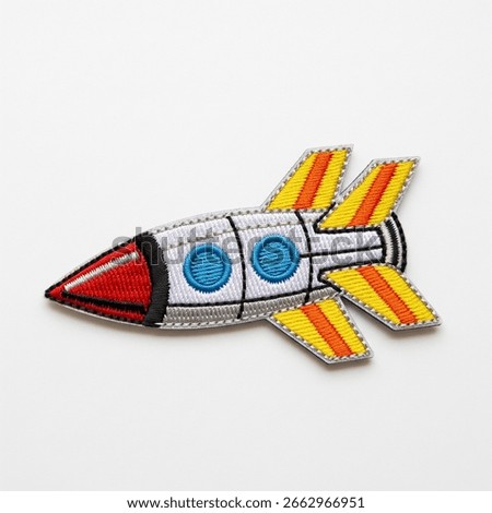textile patch in the form of a spaceship on a white background