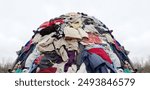 textile pollution, fast fashion industry waste, old clothing cloth fabric garment trash garbage pile stack heap  background, concept of fast fashion industry tax and recycling