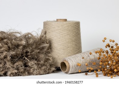 Textile, Production Of Fabrics From Flax, Thread On A Spool And Dry Flax On A White Background.