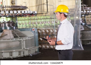 Textile Production Manager Working Inside Factory