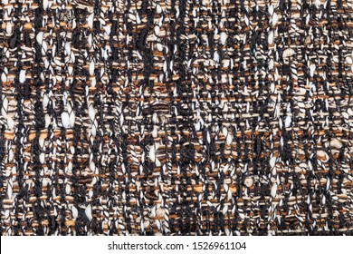 textile square background - interlacing of threads in motley boucle fabric close up