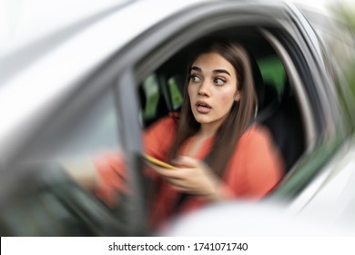 Texting And Driving, Behind The Wheel. Breaking The Law. Woman Driving Car Distracted By Her Mobile Phone Causing An Accident