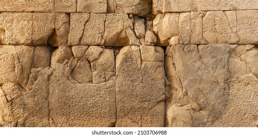 texture of an ancient wall made of huge stone blocks cracked from time