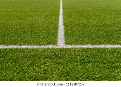 Texture of artificial grass herb cover sports field. It is used in different sports: football, tennis, baseball, soccer, american football, cricket, golf, field hockey, rugby. - Shutterstock ID 1112187257