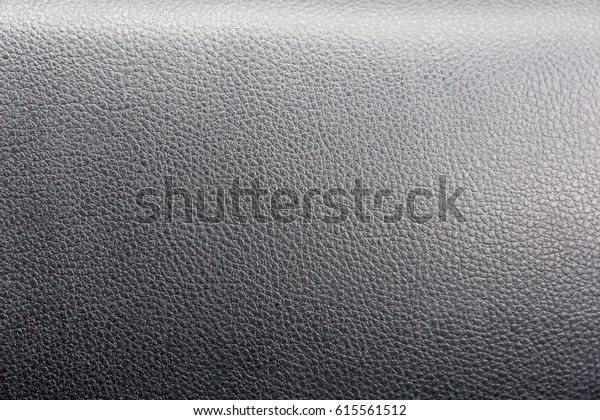 Texture of the artificial leather background on\
the car panel dashboard