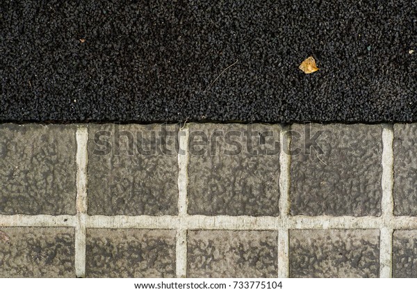 Texture of asphalt road and cement tiles with\
some dirt cover it, using as\
background