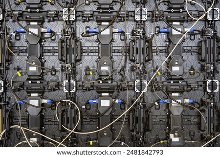 Texture of back view panels. Power input and output wire and data input and output plug. Digital electronic screen. Backside of big LED screen monitor display