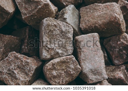 Texture backdrop background pile, wall of stone, bricks, cobblestones of brown and gray colors, rectangular, parallelepiped forms.