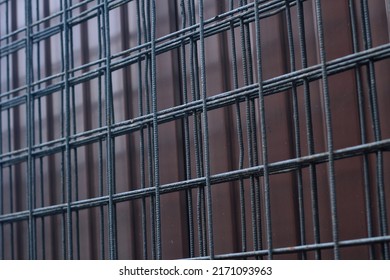 Texture background: black metal iron grating, grid with geometric square design pattern, steel grate. Dark interior fence, mesh, lattice
