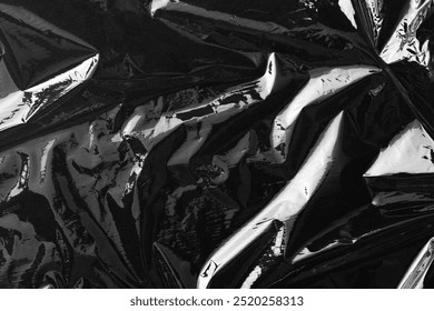 Texture background, black plastic. Plain dark black background, simple desktop background with cellophane. Cool black wallpaper background. Plastic sheet overlay on black backdrop.