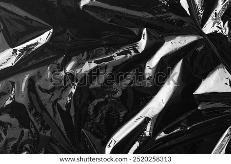 Texture background, black plastic. Plain dark black background, simple desktop background with cellophane. Cool black wallpaper background. Plastic sheet overlay on black backdrop.