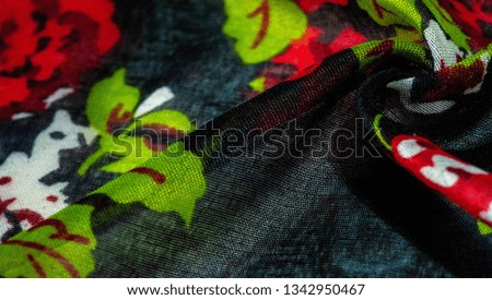 Texture background, dark blue silk fabric with roses painted colors, colors are blue red white green red white green