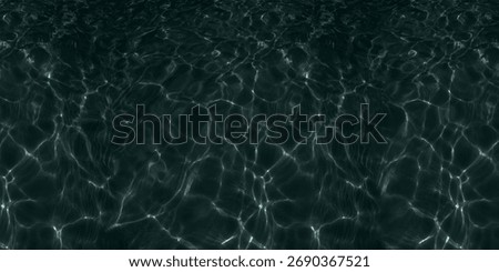 Texture background dark, deep water with a mesmerizing pattern of light reflections. The image captures the surface of water, likely a sea, ocean, or swimming pool, from directly above. 