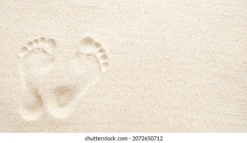 Texture background, Footprints of human feet on the sand, top view with copy space