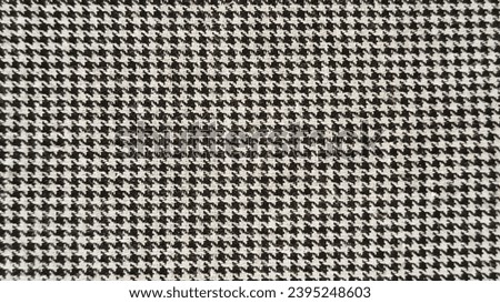 Texture background of houndstooth pattern fabric in black and white color. Fabric texture close-up, background, wallpaper.