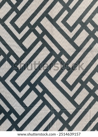Texture. Background. Intertwined thick black lines cross each other on the gray background to form a network.