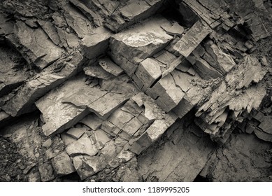 Texture, background layers and cracks in sedimentary rock on cliff face. Cliff of rock mountain. Rock slate in the mountain. Seamless abstract background. Cracks and layers of sandstone. - Shutterstock ID 1189995205
