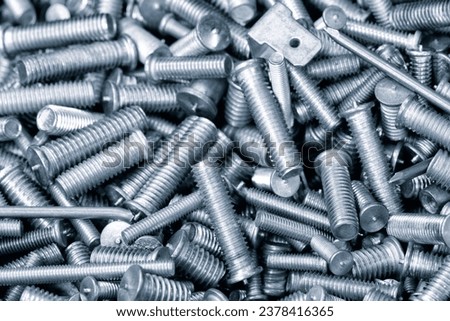 Texture background of metal products screws, nozzles, bolts and studs for welding equipment, industrial concept background