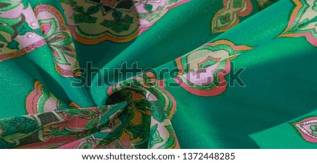 texture, background, multicolored silk fabric with a pattern of patterns on a green background, jacquard pattern