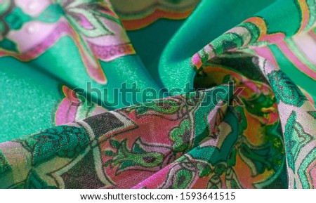 texture, background, multicolored silk fabric with a pattern of patterns on a green background, jacquard pattern