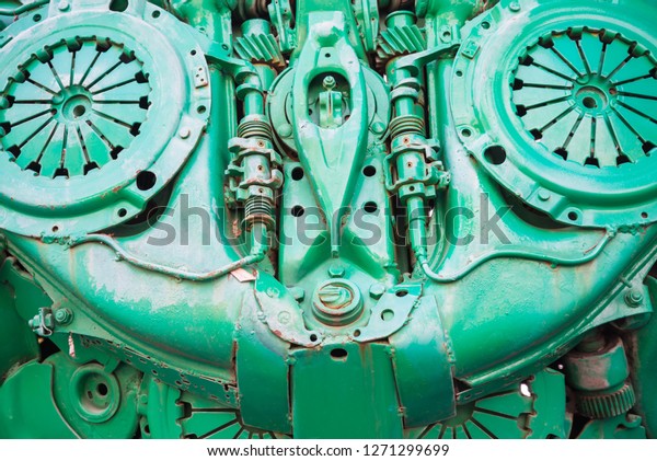 Texture background painted green robot body made\
from steel metallic of auto parts. Bolt, nut, pipe, shaft, gear,\
clutch, spring wire
