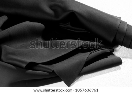 Texture. Background. Pattern. Black fabric for cutting clothes. Excellent evening dress, great design