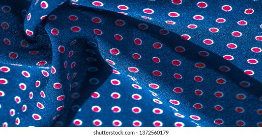 Texture background, pattern, blue silk fabric with red polka dots.