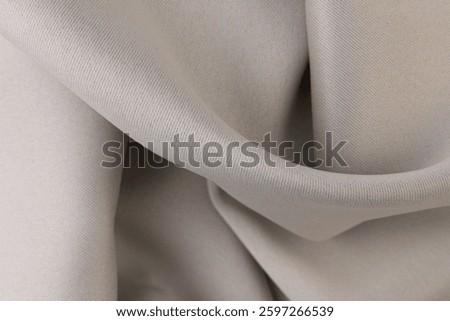 Texture, background, pattern. The fabric is beige, with a slight roughness.