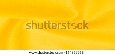 Texture background pattern Fabric warm wool yellow A pair of acrylic felt fabric has a phenomenal color. Condensation of felt oil and pressing the fibers together This is a special fabric for design