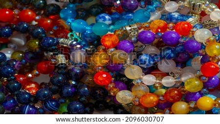 Texture, background, pattern. Folk art. Beads from multi-colored stones and glass