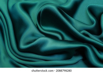 Texture, background, pattern. Texture of green silk fabric. Beautiful emerald green soft silk fabric. - Shutterstock ID 2088798280