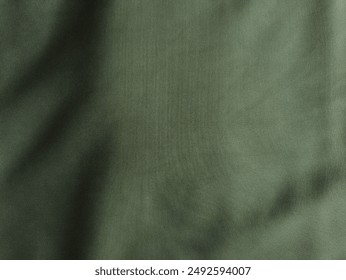 Texture, background, pattern. Texture of green silk fabric. Beautiful emerald greens soft silk fabric. Dark green background. View on above. For table background. 