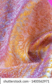 Texture background, pattern. pink brocade fabric. Organza brocade fabric - shepherd, with a crunchy palm. It has a large yarn-dyed flower embroidered pattern throughout.