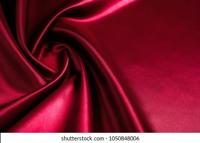 Texture, background, pattern. Red silk fabric.This satin fabric is perfect for making fabric flowers for use in hair accessories, jewery making, and fabric bouquets. 