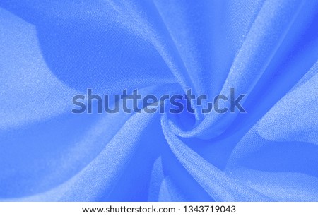 Texture, background, pattern, silk blue fabric. Crepe satin on the back is an excellent fabric for design, on the one hand it has a satin finish, and on the other - crepe, which makes it reversible,