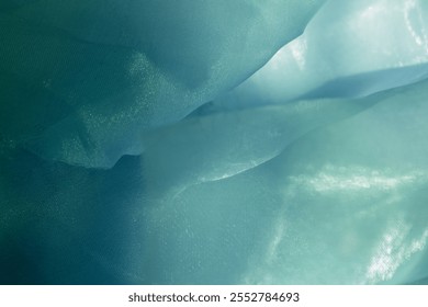 Texture, background, pattern. Silk fabric in light sea green color as background. abstract folds.
Smooth elegant dusty green silk or satin texture. Pistachio, fern, teal, sapphire, ocean green