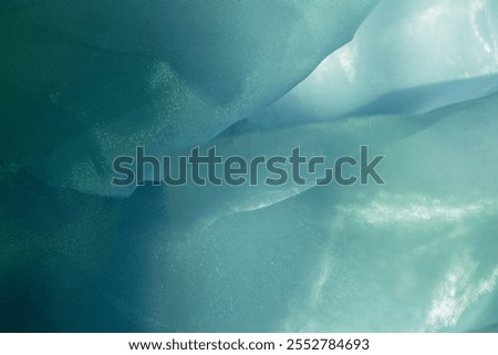 Texture, background, pattern. Silk fabric in light sea green color as background. abstract folds.
Smooth elegant dusty green silk or satin texture. Pistachio, fern, teal, sapphire, ocean green
