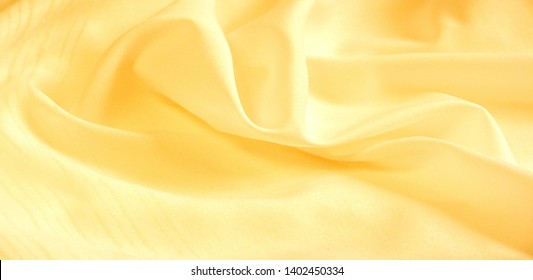texture background, pattern. silk yellow fabric. From Telio, this organza has a thin, open weave that is thicker and sharper than silk gauze. Use this luxurious fabric for anything. The possibilities 