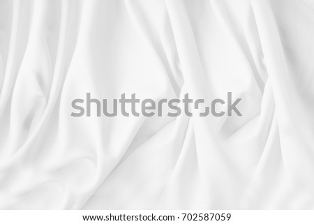 Texture, background, pattern. White cloth background abstract with soft waves, great for dresses or suits, where transparency and flow are required.