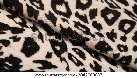 Texture, background, pattern, women's woolen shawl, black and beige, African motifs, shawl made of wool and modal with print in the form of a snake with a hem.