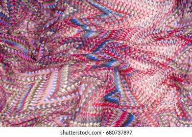 Texture, background, pattern. A woolen woolen card of Missoni color. White, red, brown, black. Abstract drawing.
