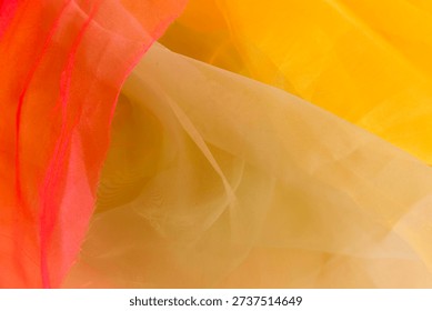 Texture background pattern.Silk fabric in light tan yellow orange as background. abstract folds.Smooth elegant color silk or satin texture.vibrant sun tangerine gold mango nude skin color aesthetic bg