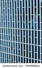 Texture background: protective gray metal iron grating, grid or stainless steel grate in perspective. Venting, ventilation