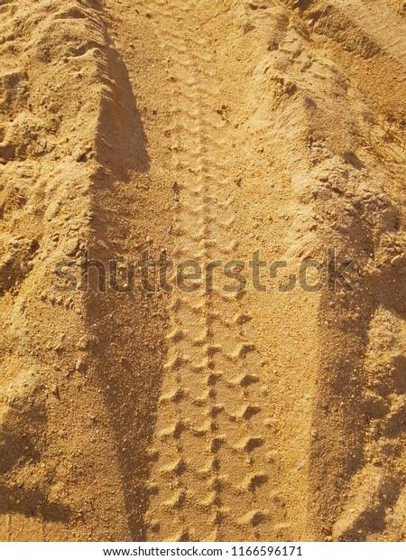 Texture and\
Background with tire mark on dirt\
road