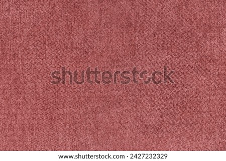 Texture background of velours jacquard red fabric. Upholstery texture fabric, velvet furniture textile material, design interior, decor. Fleecy fabric texture close up, backdrop, wallpaper.
